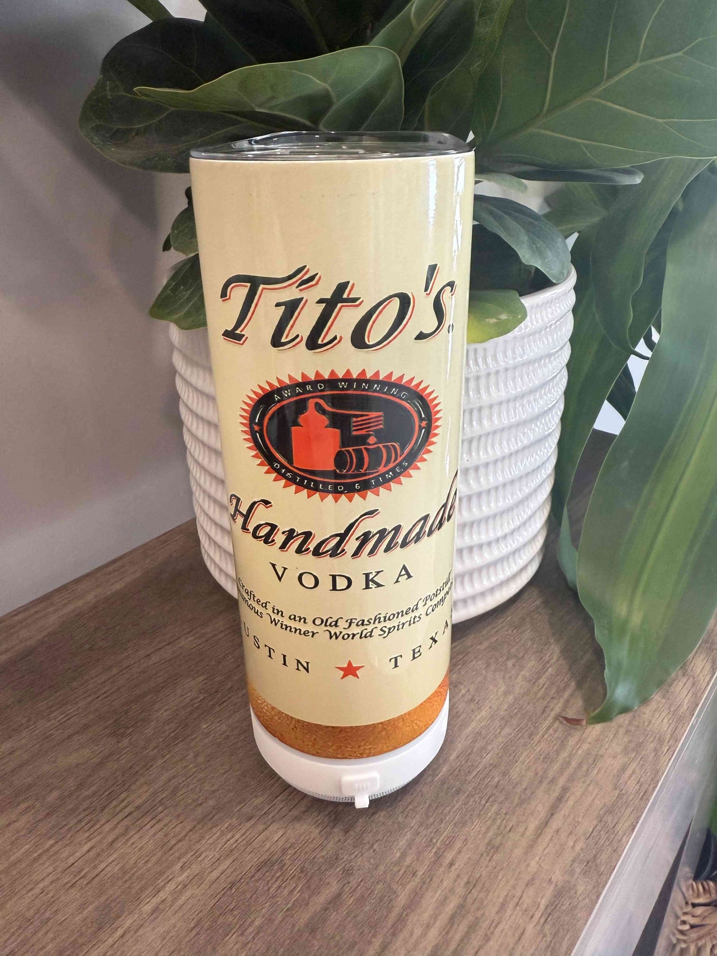 Tito ThermoMug – The Ultimate Insulated Mug for Hot & Cold Drinks, designed to resemble a Tito's Handmade Vodka bottle with a flip-top lid.