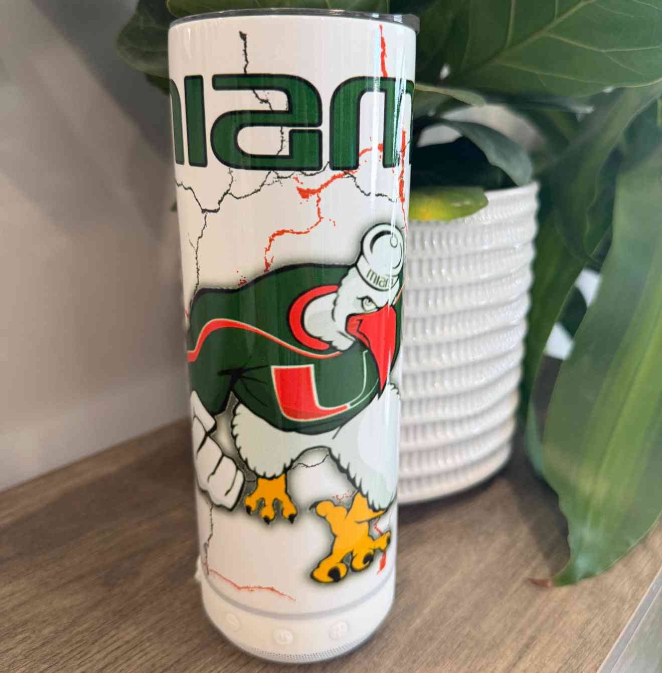 Melody Drinkware tumbler featuring University of Miami mascot design with cracked texture and vibrant colors, ideal for stylish beverage use.