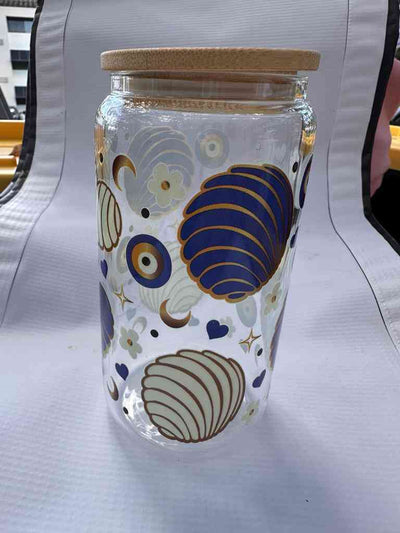 Stylish Premium Glass Can with seashell and floral design in blue and gold, perfect for eco-friendly and decorative beverage storage.